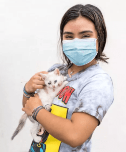 A girl holding her shite kitten