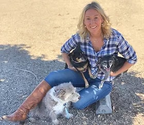 Isabelle Gullo, C.A.R.E.4Paws Cofounder and Executive Director with three small dogs